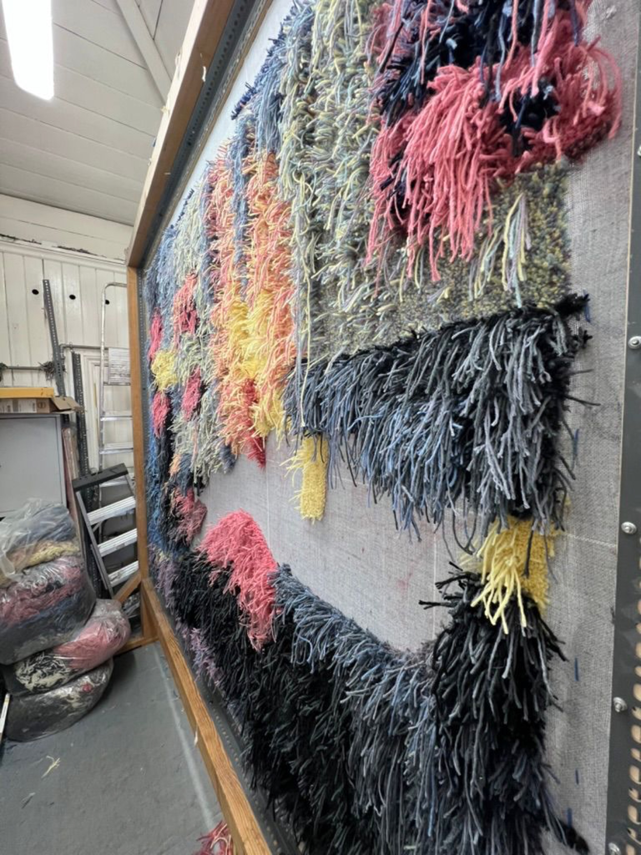 Building the tufted textile from its reverse side